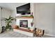 Close-up of a charming fireplace with a shiplap surround, wooden mantel, and decorative accents at 5043 White Chicory Dr, Apollo Beach, FL 33572