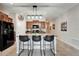 Stylish kitchen island with seating, granite countertops and modern lighting fixtures at 5043 White Chicory Dr, Apollo Beach, FL 33572