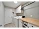 Laundry room featuring white appliances, wood countertop, and storage cabinets at 5043 White Chicory Dr, Apollo Beach, FL 33572