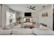Bright living room with a cozy fireplace, ceiling fan and large window allowing for lots of natural light at 5043 White Chicory Dr, Apollo Beach, FL 33572