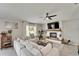 Cozy living room showcasing a decorative fireplace, plush sectional sofa, and stylish decor at 5043 White Chicory Dr, Apollo Beach, FL 33572