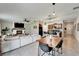 Spacious open-concept living area with a dining table, comfortable seating, and a fireplace at 5043 White Chicory Dr, Apollo Beach, FL 33572