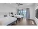 This comfortable bedroom offers two beds, hardwood floors, and sliding glass doors to a balcony at 5212 62Nd S Ave, St Petersburg, FL 33715