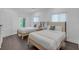 Bright bedroom features two beds, natural light, wood floors, and minimalist decor at 5212 62Nd S Ave, St Petersburg, FL 33715