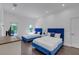 Bright bedroom features two blue velvet beds and ample natural light from the windows at 5212 62Nd S Ave, St Petersburg, FL 33715
