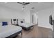 This bedroom features two beds, ceiling fan, hardwood floors, and ample lighting at 5212 62Nd S Ave, St Petersburg, FL 33715