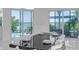 This open dining room features large windows providing serene water views and a modern black table at 5212 62Nd S Ave, St Petersburg, FL 33715