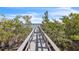 Picturesque dock leading to a calm body of water, surrounded by lush greenery and mangroves at 5212 62Nd S Ave, St Petersburg, FL 33715