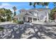 Back exterior view of home, showcasing its tile roof and well manicured landscaping at 5212 62Nd S Ave, St Petersburg, FL 33715