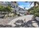 Stunning white home featuring a brick driveway, lush landscaping, and elegant architectural details at 5212 62Nd S Ave, St Petersburg, FL 33715