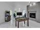 Game room featuring foosball table, arcade game, and a modern fireplace at 5212 62Nd S Ave, St Petersburg, FL 33715