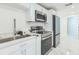 Well-lit kitchen with stainless steel appliances and stylish black and white countertops at 5212 62Nd S Ave, St Petersburg, FL 33715