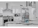 Modern kitchen featuring sleek white cabinets, stainless steel appliances, and a stone waterfall island at 5212 62Nd S Ave, St Petersburg, FL 33715