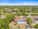 An aerial view of the house and pool surrounded by mature trees in a residential area at 603 Royal Crest Dr, Brandon, FL 33511