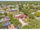 Aerial view of home with pool surrounded by lush greenery and neighborhood, showcasing the property's private backyard oasis at 603 Royal Crest Dr, Brandon, FL 33511