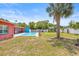An eye-level of the well-maintained lawn and pool area with mature landscaping and shade trees at 603 Royal Crest Dr, Brandon, FL 33511