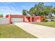 Coral-colored home boasting an attached garage, a well-manicured lawn and concrete driveway at 603 Royal Crest Dr, Brandon, FL 33511
