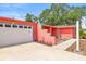 Eye-level view of coral house with white garage door, concrete driveway and walkway at 603 Royal Crest Dr, Brandon, FL 33511