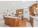 Open kitchen with breakfast bar, wooden cabinetry, and seamlessly flows into the dining area at 603 Royal Crest Dr, Brandon, FL 33511