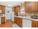 Charming kitchen sink area with white appliances, wood cabinets, and a view of the pool at 603 Royal Crest Dr, Brandon, FL 33511