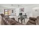 Cozy living room with a brown sectional, glass doors leading to a pool, and neutral carpet at 603 Royal Crest Drive Dr, Brandon, FL 33511