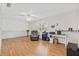 Spacious living room featuring a ceiling fan, hardwood floor, and natural light from the window at 603 Royal Crest Dr, Brandon, FL 33511