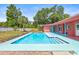 A beautiful backyard view of the refreshing pool with easy step access and surrounding patio at 603 Royal Crest Dr, Brandon, FL 33511