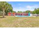 View of backyard pool and home's pink exterior with a fenced yard on a sunny day at 603 Royal Crest Dr, Brandon, FL 33511