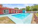 Backyard view with a large swimming pool, outdoor seating, and a colorful home exterior at 603 Royal Crest Dr, Brandon, FL 33511