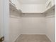 A very empty walk-in closet with shelving and carpeted floor at 603 Royal Crest Drive Dr, Brandon, FL 33511