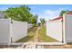 A view from the yard showing a manicured pathway through the fenced-in backyard at 603 Royal Crest Dr, Brandon, FL 33511