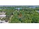 Aerial view of a property nestled amongst the trees in a lush green community near the water at 706 S 56Th St, Tampa, FL 33619