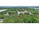 Aerial view of a property nestled amongst the trees in a lush green community near the water at 706 S 56Th St, Tampa, FL 33619