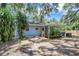View of the backyard highlighting the patio, lush greenery, and privacy at 706 S 56Th St, Tampa, FL 33619