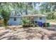 Backyard showing a patio area, landscaping, shade trees, and privacy fence at 706 S 56Th St, Tampa, FL 33619