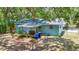 View of the backyard showcasing outdoor dining on the covered porch and landscaping at 706 S 56Th St, Tampa, FL 33619