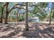 Spacious backyard surrounded by mature shade trees and a wooden privacy fence at 706 S 56Th St, Tampa, FL 33619