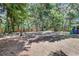 Expansive backyard with mature trees and a partial view of the privacy fence at 706 S 56Th St, Tampa, FL 33619