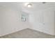 Neutral bedroom features a bright window and neutral carpeting at 706 S 56Th St, Tampa, FL 33619