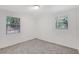 Bedroom with carpeted floor and two large windows allowing natural light at 706 S 56Th St, Tampa, FL 33619