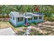 Charming single-story home with blue siding, black shutters and landscaped front yard at 706 S 56Th St, Tampa, FL 33619