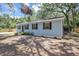 Charming single-story home with blue siding, black shutters, and landscaping at 706 S 56Th St, Tampa, FL 33619