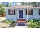Charming home featuring a welcoming front porch and a vibrant blue front door at 706 S 56Th St, Tampa, FL 33619