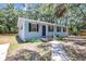 Charming single-story home with light blue siding, black shutters, and well-manicured landscaping at 706 S 56Th St, Tampa, FL 33619