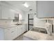 Updated kitchen with white cabinets, modern countertops, and stainless steel appliances at 706 S 56Th St, Tampa, FL 33619