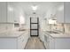 Bright kitchen featuring white cabinets, marble countertops and stainless steel appliances at 706 S 56Th St, Tampa, FL 33619