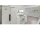 Bright kitchen featuring white appliances, ample cabinet space, and modern flooring at 706 S 56Th St, Tampa, FL 33619