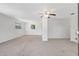 Spacious living room with neutral carpet, ceiling fan and natural light through the windows at 706 S 56Th St, Tampa, FL 33619