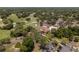 Aerial view of the golf course, pool, clubhouse, and community parking at 7535 Greystone Dr, Hudson, FL 34667