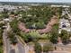Scenic aerial view of a residential neighborhood with mature trees and well-maintained homes and roads at 7535 Greystone Dr, Hudson, FL 34667